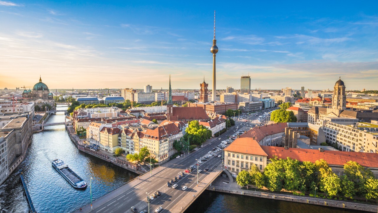 Aerial view of Berlin skyline with famous TV tower and Spree river in beautiful evening light at sunset, Germany.