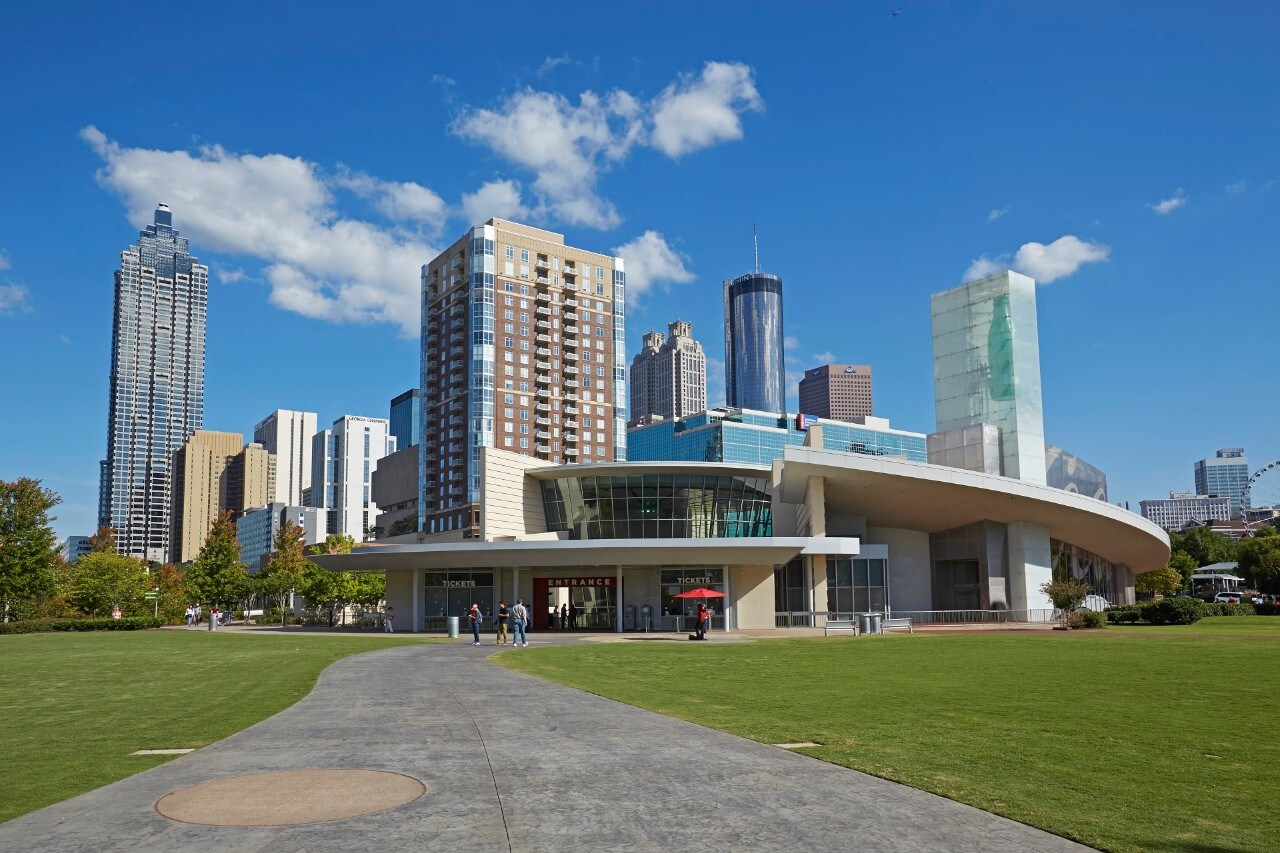 Cityscape of the skyscrapers of Downtown Atlanta from the 'Centennial Olympic Park' with the 'World of Coca Cola' attraction in foreground.